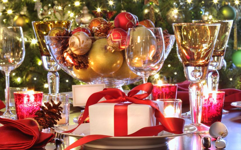 Elegant  holiday table setting with red ribboned gift