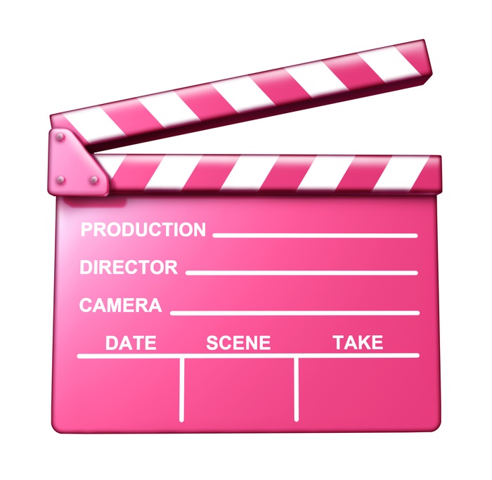 Chick flick pink clap board female target audience movies symbol represented by an isolated romantic love theme film slate.